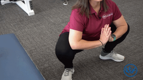 Physical therapist demonstrates the deep yoga squat, a great pregnancy exercise for pelvic health.