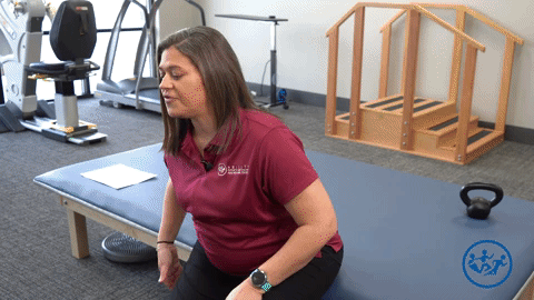 Physical therapist demonstrates the hamstring stretch, a great pregnancy exercise for pelvic health.