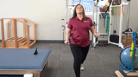 Physical therapist demonstrates lunges, a great pregnancy exercise for pelvic health.